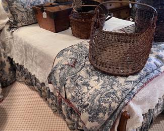 Full size antique French bed. Beautiful toile custom bedding. Antique gathering baskets