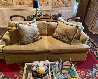 Custom upholstered sofa, needlepoint pillows, Gochman 10’11” x 9’5” rug (as is, has damage)