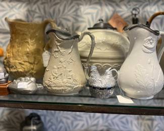 Antique pitcher (back left), rare Olde Bargee cream tea pot with pewter lid (back center), 19th century salt glaze stoneware pitcher with pewter lid (front right), T. Booth Hanley relief molded jug (front left)