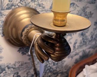 Close up of brass hand sconce