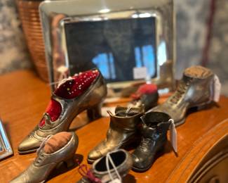 Collection of antique pin cushion shoes and ink wells