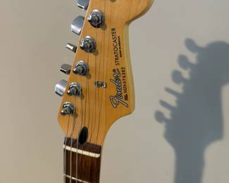 C16 - $250 - Fender Stratocaster Serial # MZ6076392. Model #0134600306. FENDER STD STRAT RW BLK.  05/2006. Has significant cracking all around the black case that surrounds the wooden guitar body. 