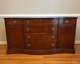 C31 - $250. Bassett Buffet. Measures 62.5" wide x 21.5" deep x 33" tall. Monticello. All drawers slide. Small area on the top that has surface damage - see photo. 
