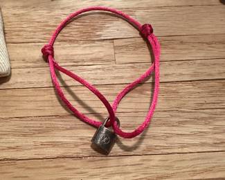 J27 - $150. Silver Lockit Bracelet with Pink Polyester Cord. Includes bag & gift box. 