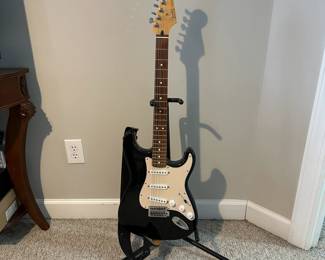 C16 - $250 - Fender Stratocaster Serial # MZ6076392. Model #0134600306. FENDER STD STRAT RW BLK.  05/2006. Has significant cracking all around the black case that surrounds the wooden guitar body. 