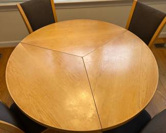 C44 - $650. Skovby Model SM32MB Maple. Made in Denmark. Extending Segmental Pedestal Dining Table. Table measures 47" round x 28.5" tall. With Pop Up leaves it is 57" wide. Chairs need cleaned or reupholstered.  Table shows signs of wear. By turning the turntable under the tabletop the three leaves move synchronously to a position that makes room for the extension leaves in the base. When light pressure is applied the extension leaves unfold by means of a spring placed under the triangle in the middle of the table. 