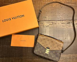 C105 - $1450. Louis Vuitton Pochette Metis Monogram Reverse. With Box and Authenticity Certificate. Has minor cracking and scratches on the metal. If you would like to see prior to committing please let me know when you reach out. 