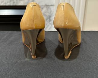C117 - $125. Size 35. Jimmy Choo Nude Patent Leather with Gold Tone Wedge Heels. 