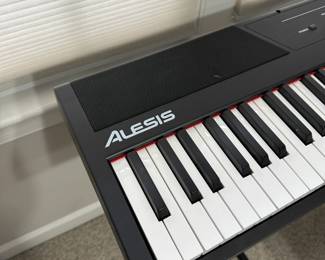 C13 - $85 - Alesis Recital Digital Piano with Full Size Keys. Includes Stand & Stool. Does have  a little bit of sticker residue on the keys from learning to play!