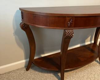 C55 - $75 Demi Lune Entry Table #2. Measures 52" wide x 18" deep x 30.5" tall. 