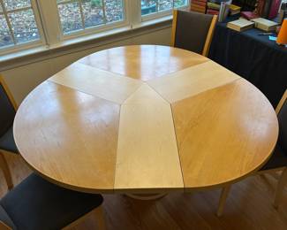 C44 - $650. Skovby Model SM32MB Maple. Made in Denmark. Extending Segmental Pedestal Dining Table. Table measures 47" round x 28.5" tall. With Pop Up leaves it is 57" wide. Chairs need cleaned or reupholstered.  Table shows signs of wear. By turning the turntable under the tabletop the three leaves move synchronously to a position that makes room for the extension leaves in the base. When light pressure is applied the extension leaves unfold by means of a spring placed under the triangle in the middle of the table. 