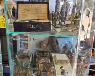 A few lead soldiers left, fishing reels, vintage cars and military trucks