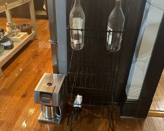 COOL IRON RACK HOLDING EMPTY WINE BOTTLES