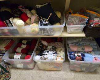 Tubs of yarn and knitting needles 