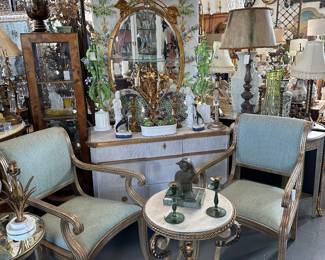 Pair silvergilt Klismos armchairs; Painted Gustavian commode; Metal side table, round marble top; Oval giltwood mirror with foliate pediment, and more.