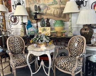 Pair of painted Italian fauteuils upholstered in leopard; Whimsical painted Italian occasional table with faux top; Handpainted Italian wall panel, Pair of wrought iron sconces, and more