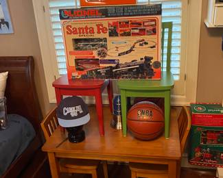 Great Pieces of Vintage Lionel Train Accessories Available Shown with a Pottery Barn Kids Table and 8 Multi-Colored Chairs.