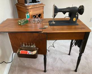 Singer sewing machine inside cabinet