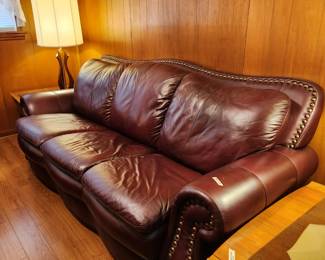 #55	Burgundy Pleather Sofa w/brass nail head Trim - 88x37x36" Long (one small tear)	 $300.00 
