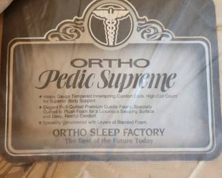 #33	Antique Wood Headboard w/carvings in Center and top w/rounded Wood Footboard w/Cream Spread and Orto Pedic Supreme Mattress/Boxsprings (still in plastic) & 2 plastic covered pillows)	 $300.00 
