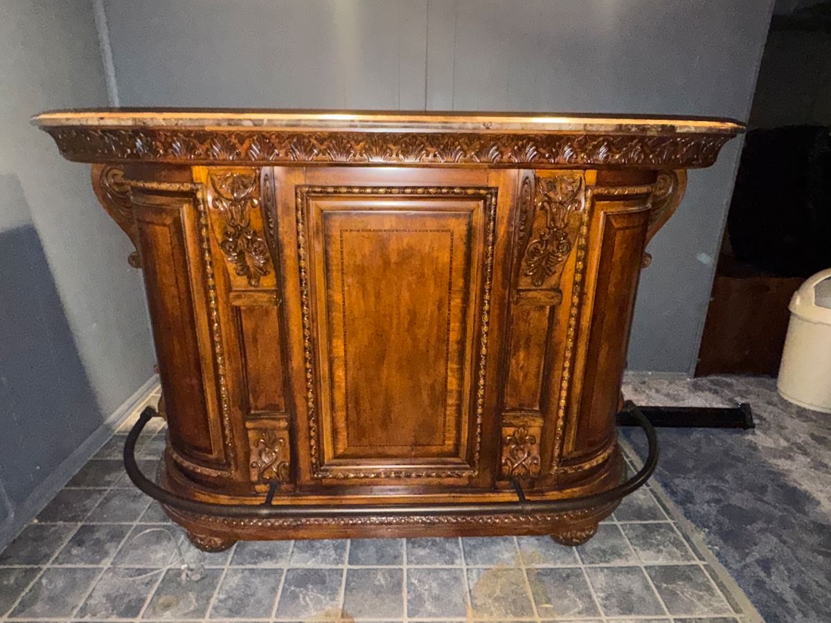 Beautiful ornate solid wood dry bar with granite bar top. 