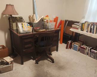 Desk, office chair, books, ephemera