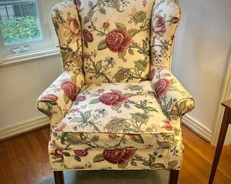 One of two floral custom-upholstered wingback chairs