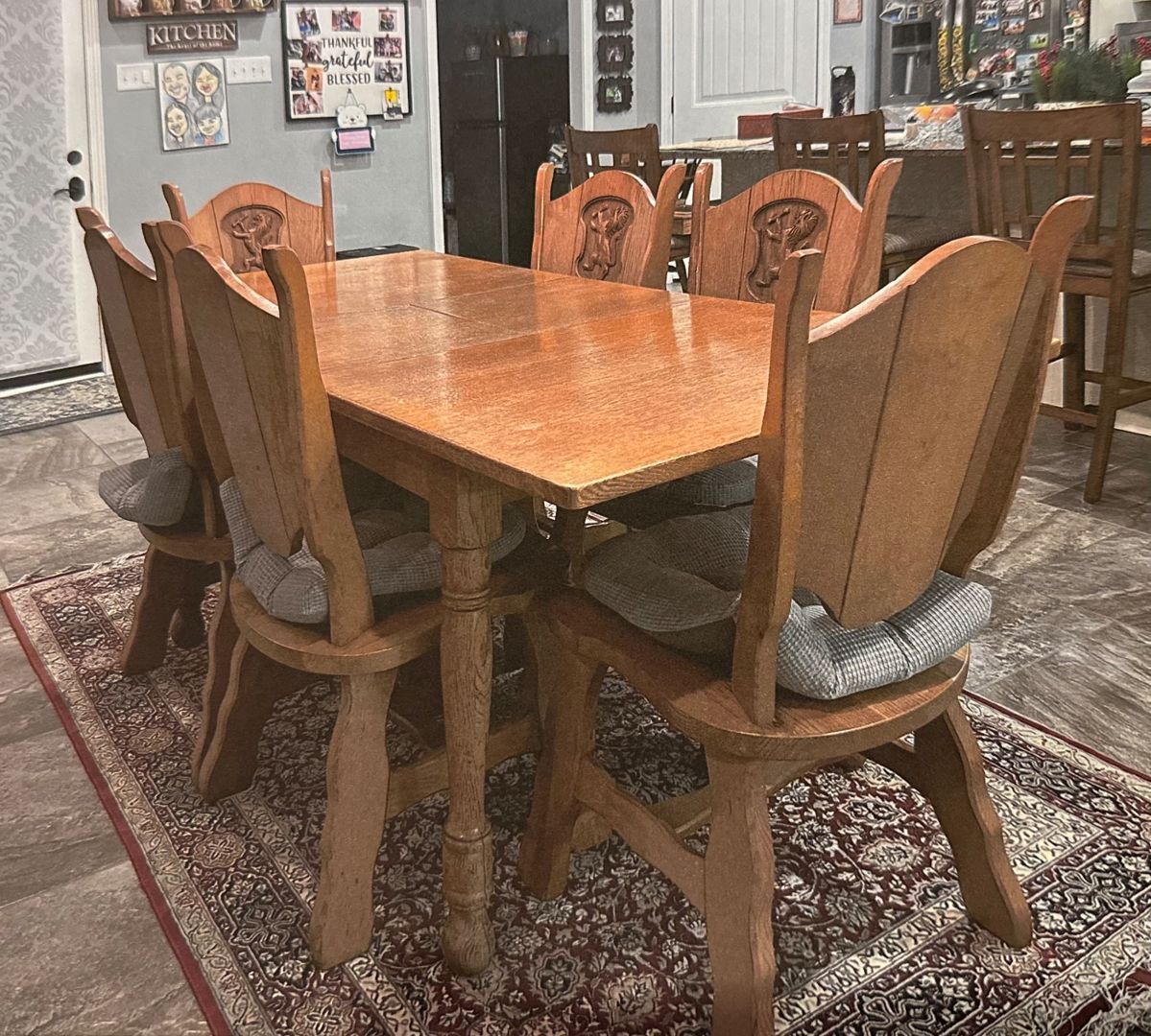 Very heavy and sturdy antique table and 6 chairs from Holland.  Chairs have lion carving.  Table has built in leaf.  