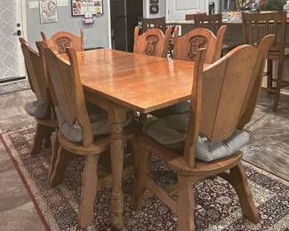 Very heavy and sturdy antique table and 6 chairs from Holland.  Chairs have lion carving.  Table has built in leaf.  