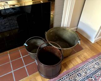 Antique buckets, one wood and two brass.