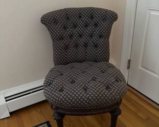 Upholstered, tuffeted slipper chair.