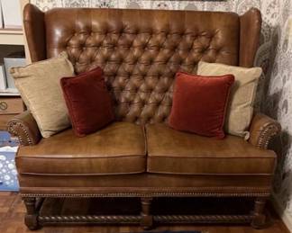 Faux Leather Love Seat
Tufted Faux leather loveseat with carved wing shape and brass studs.