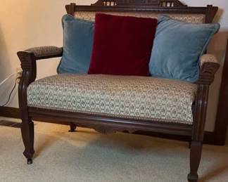 Vintage wood upholstered settee on casters