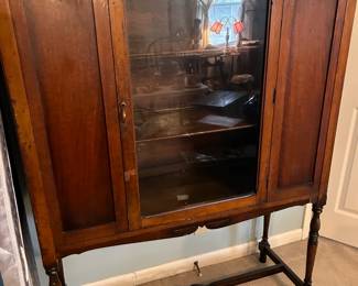 #150 Wooden China cabinet with front glass door, two wooden shelves with plate rack. On legs. 44 x 16 x 59 $125.00