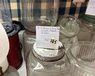 #125 3 vintage glass jars with lids, ribbed sides $35.00