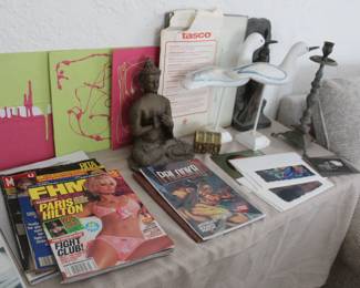 comic books, vintage Paris Hilton magazine, brass statue, brass candle sticks 