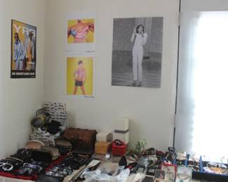 costume jewelry, sunglasses, Whitney Houston poster, andre 3000 poster 