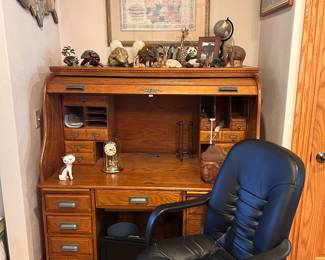 S-curve roll top computer desk with computer chair, wall maps, agate book ends & various souvenirs.