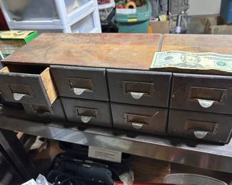 An 8 wood drawer file cabinet.