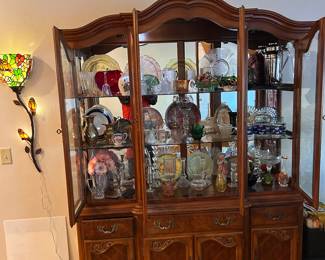 China lite hutch with lots of glassware and knick-knacks. Note the 'floral wall light on the left.