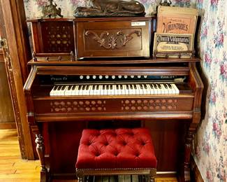 Antique organ.  LOVE THE DOG AND ANTIQUE CANDELABRAS.