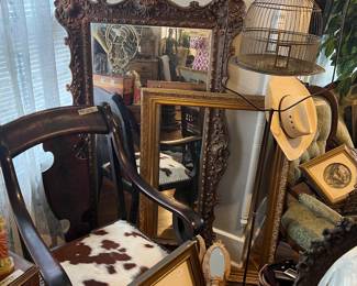 MIRRORS, FRAMES, ANTIQUE BIRD CAGE, AND COWHIDE ANTIQUE ARM CHAIR.