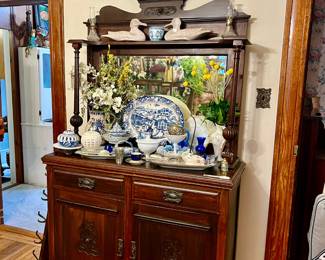 PRETTY ANTIQUE SIDEBOARD WITH ROSETTES AND RIBBONS.  FLOW BLUE, BLUE AND WHITE, MILK GLASS.