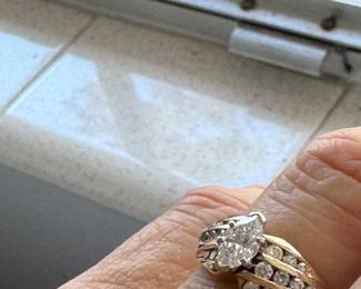 #31 - 1 carat center diamond Marquise cut with small round diamonds 3 rows on 14kt yellow gold. $2,500. 