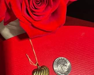 18. $150 - 14kt gold heart locket 