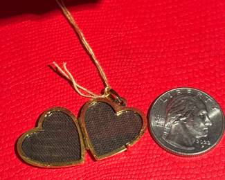 18. $150 - 14kt gold heart locket 
