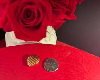 18. $150 - 14kt gold heart locket 