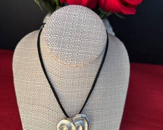 13. Yves St. Laurent silver tone heart pendant $220