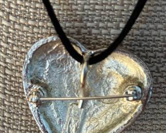 13. Yves St. Laurent silver tone heart pendant $220