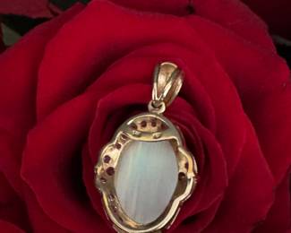 #25 - 14kt gold pendant & oval opal, bezed with diamonds. $980. Appraisal included with purchase. 